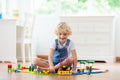 Kids play wooden railway. Child with toy train Royalty Free Stock Photo