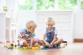 Kids play wooden railway. Child with toy train Royalty Free Stock Photo