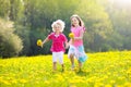 Kids play. Child in dandelion field. Summer flower Royalty Free Stock Photo