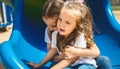 Kids on playground. Children play outdoor on school yard slide. Kid playing in sunny park. Child girls having fun on colorful Royalty Free Stock Photo
