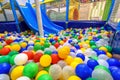 Kids playground indoor. Panoramic view inside the dry pool with colorful balls and slide. Nice plastic gym for activity in