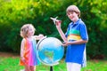 Kids playing with airplanes and globe Royalty Free Stock Photo