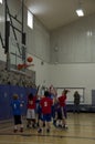 Kids playing basketball match