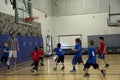 Kids playing basketball match