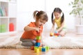 Kids playing block toys in playroom at nursery Royalty Free Stock Photo