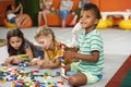 Kids playing block toys in playroom at nursery. Royalty Free Stock Photo