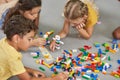 Kids playing block toys in playroom at nursery. Royalty Free Stock Photo