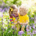 Kids playing in blooming garden with bluebell flowers Royalty Free Stock Photo