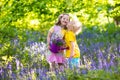 Kids playing in blooming garden with bluebell flowers Royalty Free Stock Photo