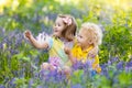 Kids playing in blooming garden with bluebell flowers Royalty Free Stock Photo