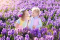 Kids playing in blooming garden with hyacinth flowers Royalty Free Stock Photo