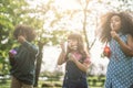 Kids playing Blowing Bubbles Together at the Field. Royalty Free Stock Photo