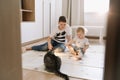 Kids playing with a cat at home. Brother and little sister having fun together Royalty Free Stock Photo