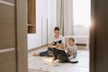 Kids playing with a cat at home. Brother and little sister having fun together Royalty Free Stock Photo