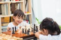 Kids playing chess - one of them just captured a pawn and celebrates