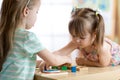 Kids playing with colorful block toys. Two children girls at home or daycare center. Educational child toys for Royalty Free Stock Photo