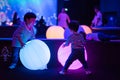 Kids are playing colorful light balls. Royalty Free Stock Photo