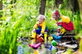 Kids playing with colorful paper boats in a park Royalty Free Stock Photo