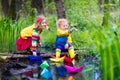 Kids playing with colorful paper boats in a park Royalty Free Stock Photo