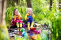 Kids playing with colorful paper boats in a park Royalty Free Stock Photo