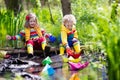 Kids playing with colorful paper boats in a park Royalty Free Stock Photo