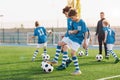 Kids playing and competing on sports soccer training. Happy children kicking balls Royalty Free Stock Photo