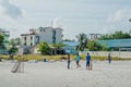 Kids playing cricket at the playground at the tropical island