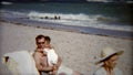 1959: Kids playing with dad and gives stoic grandma some love. MIAMI, FLORIDA