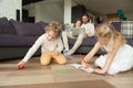 Kids playing drawing at home, family spending leisure time toget