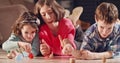 Kids playing with dreidels during Hanukka at home