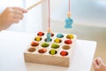 Kids are playing and finding the matched number in the wooden magnetic fishing game, using wooden fishing pole provided with