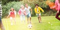 Kids playing football in park Royalty Free Stock Photo