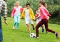 Kids playing football in park Royalty Free Stock Photo