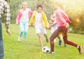 Kids playing football in park Royalty Free Stock Photo