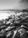 Kids playing in Goa seashore featuring rocks and sea in Black and white Royalty Free Stock Photo