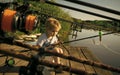 Kids playing - happy game. Adorable little boy fishing from wooden dock on lake Royalty Free Stock Photo