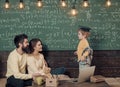 Kids playing - happy game. Homeschooling concept. Smart child in graduate cap likes to study. Parents teaching kid at Royalty Free Stock Photo