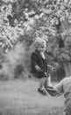 Kids playing - happy game. Small boy sit on male hand in apple garden, trust Royalty Free Stock Photo