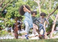 Kids playing jump over the rope in the park on sunny summer day. Royalty Free Stock Photo