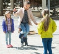 Kids playing in jump rope game Royalty Free Stock Photo