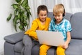 Kids playing with laptop computer at home Royalty Free Stock Photo