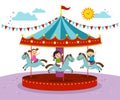 Kids playing on merry go round in an amusement park Royalty Free Stock Photo