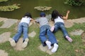 Kids playing near pond in a garden
