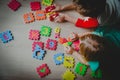 Kids playing with number puzzle, education concept