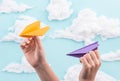 Kids playing with orange and violet paper planes Royalty Free Stock Photo