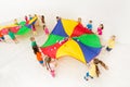 Kids playing parachute games in light gym Royalty Free Stock Photo