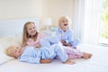 Kids in bed. Children in pajamas. Family bedroom. Royalty Free Stock Photo