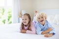 Kids in bed. Children in pajamas. Family bedroom. Royalty Free Stock Photo