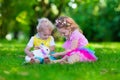 Kids playing with pet rabbit Royalty Free Stock Photo