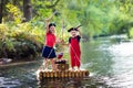 Kids playing pirate adventure on wooden raft